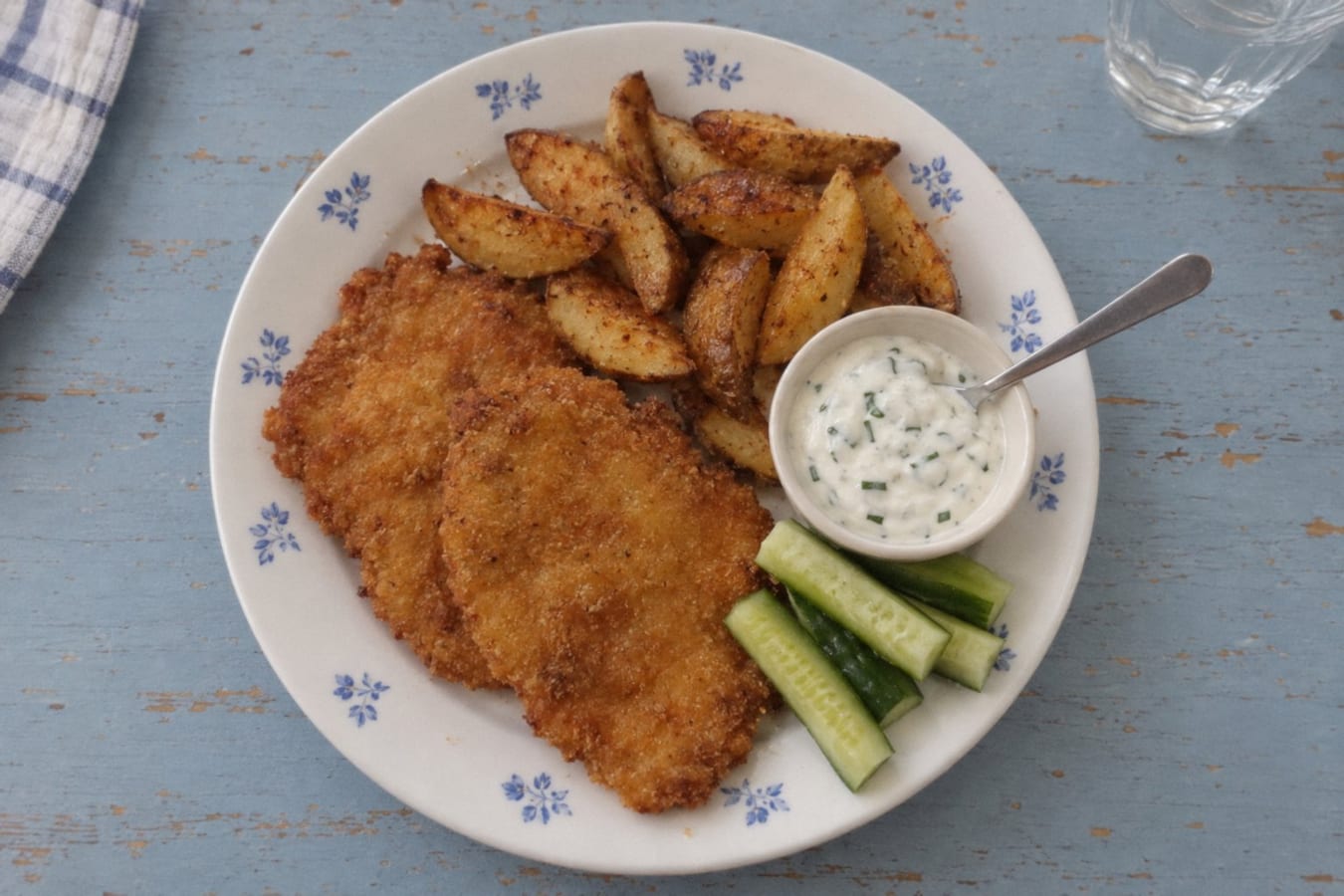 Breaded chicken with potato wedges and sour cream dip