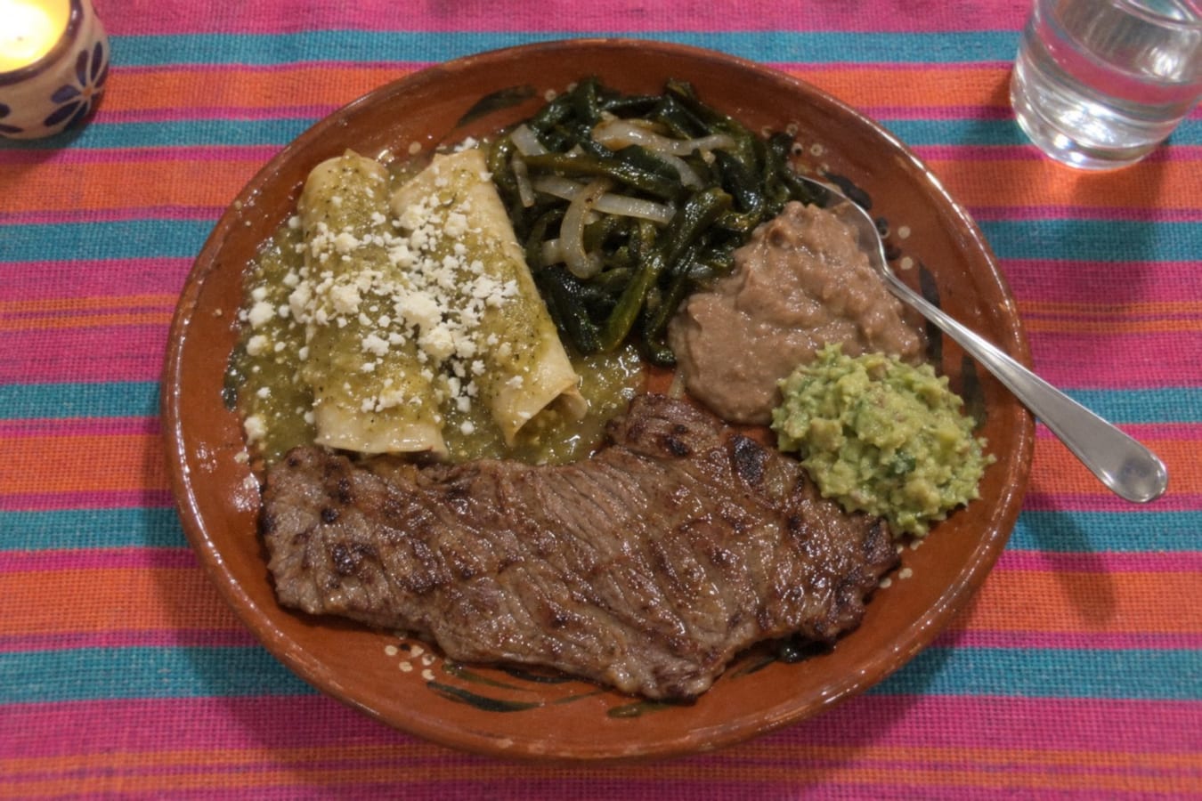 Carne a la tampiqueña – grilled steak with enchiladas, poblano strips, beans and guacamole