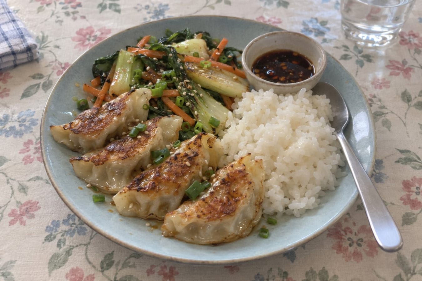 Pan-fried dumplings with rice and stir-fried greens