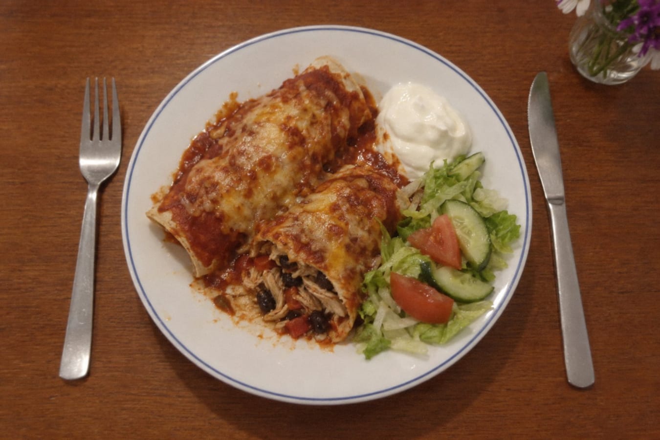 Chicken enchiladas with sour cream and salad