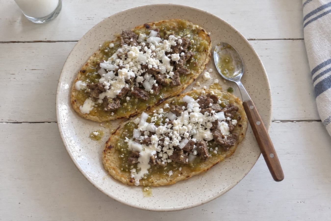 Huaraches – long masa cakes with beans, steak and green salsa