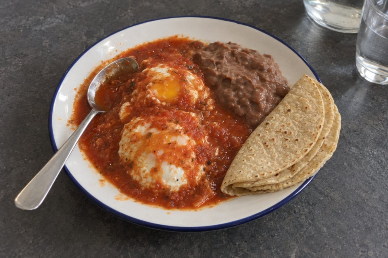 Huevos ahogados – eggs poached in red salsa