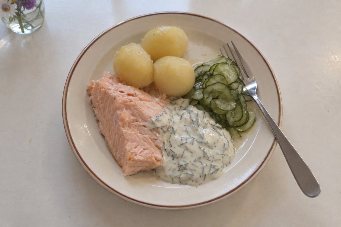 Poached salmon with dill sauce, boiled potatoes and quick-pickled cucumber