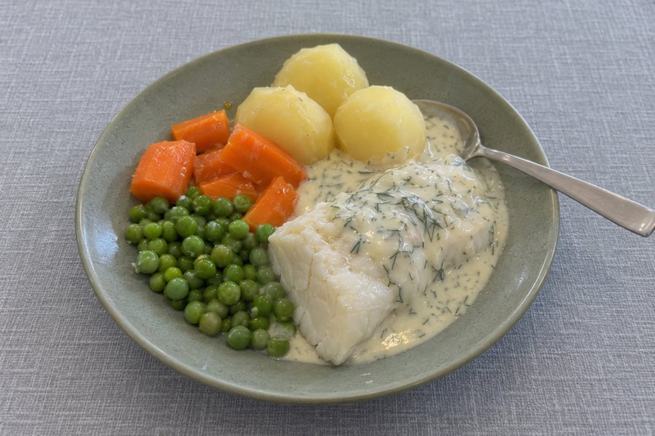 Poached cod with dill sauce, potatoes and carrots