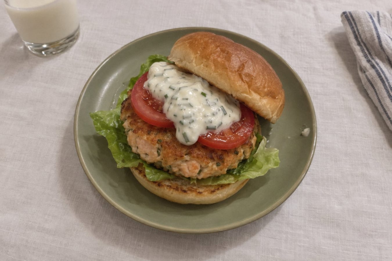 Salmon burgers with chive dressing, tomato and lettuce